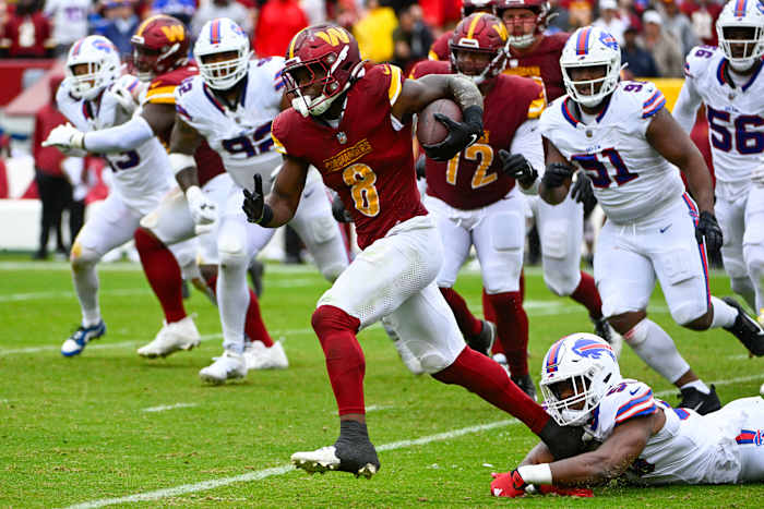 Washington Commanders running back Brian Robinson Jr. (8) carries the ball against the Buffalo Bills during the second half at FedExField.